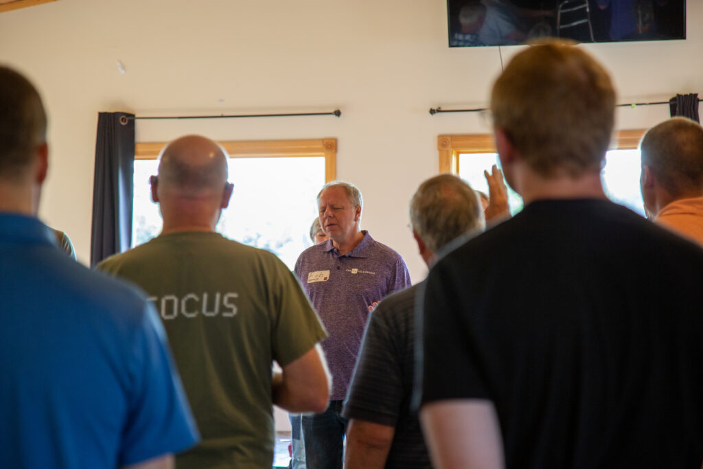 Pastor leading a room in prayer