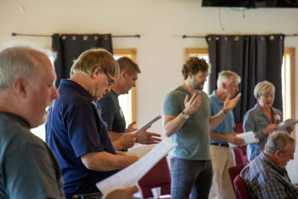 Seven people singing and worshipping at the Midwest Prayer Summit